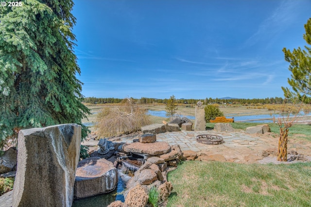 52995 Riverview Dr, La Pine, OR 97739 - view of patio with an outdoor fire pit and a water view