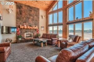 52995 Riverview Dr, La Pine, OR 97739 - living room with high vaulted ceiling, wood ceiling, a large fireplace, carpet flooring, and a water view