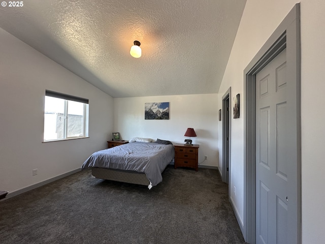 bedroom with baseboards, dark carpet, a textured ceiling, and lofted ceiling