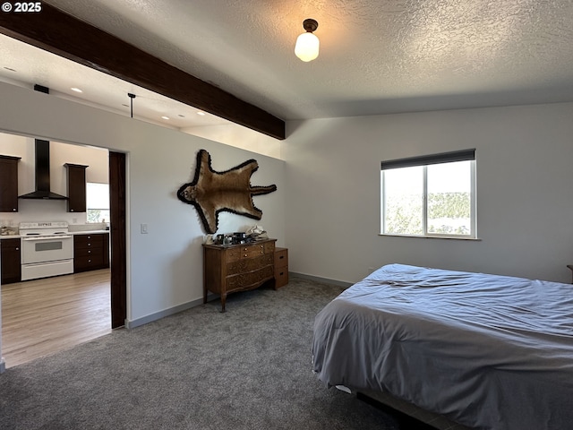 bedroom featuring light colored carpet, a textured ceiling, baseboards, and beamed ceiling
