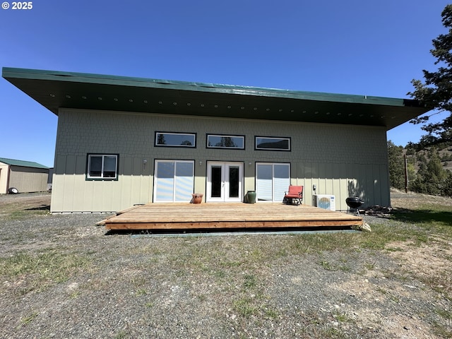 rear view of house with french doors and a wooden deck