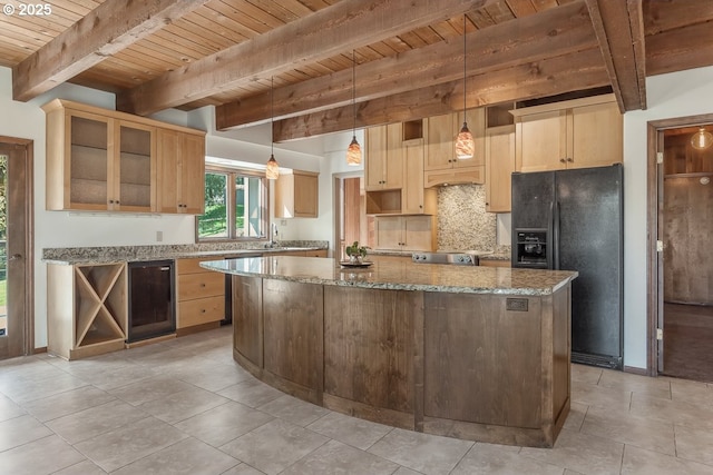 27690 SW Strawberry Hill Dr, Hillsboro, OR 97123 - kitchen with black fridge with ice dispenser, wooden ceiling with exposed beams, decorative backsplash, a center island, and light stone countertops