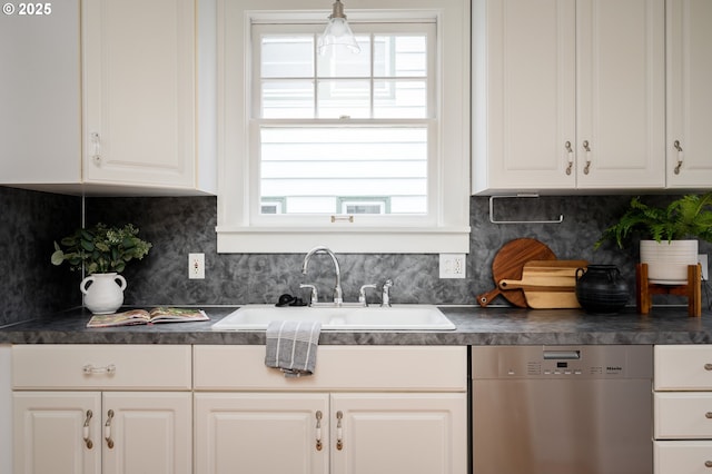 kitchen featuring white cabinets, backsplash, dishwasher, and sink