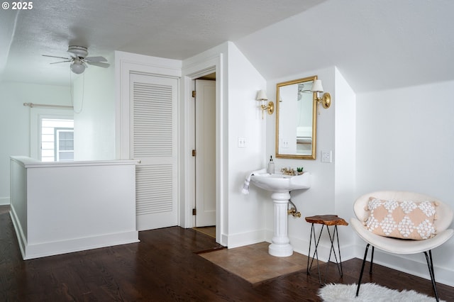 bathroom with lofted ceiling, wood-type flooring, a textured ceiling, and ceiling fan