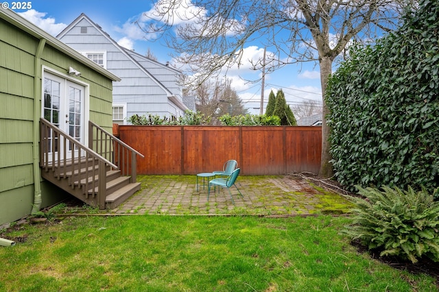 view of yard featuring a patio area and french doors