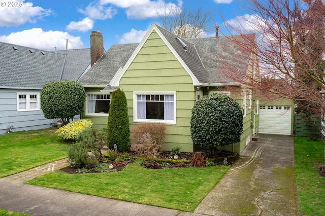 view of front facade with a front yard and a garage