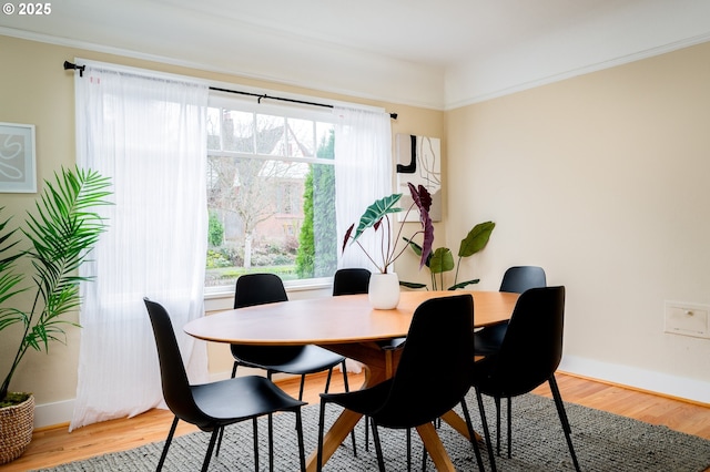 dining area with plenty of natural light and hardwood / wood-style flooring