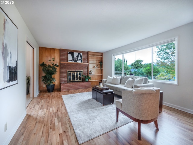 2625 Potter St, Eugene, OR 97405 - living room featuring baseboards, light wood-type flooring, a brick fireplace, and built in shelves
