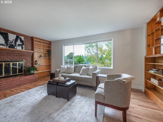 2625 Potter St, Eugene, OR 97405 - living room featuring built in shelves, wood finished floors, a brick fireplace, and baseboards