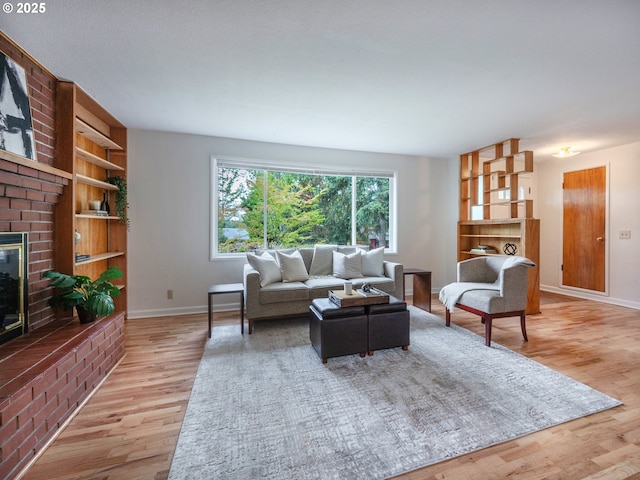 2625 Potter St, Eugene, OR 97405 - living room featuring wood finished floors, a brick fireplace, baseboards, and built in shelves