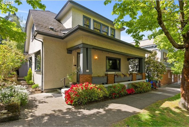 view of front facade featuring stucco siding and covered porch