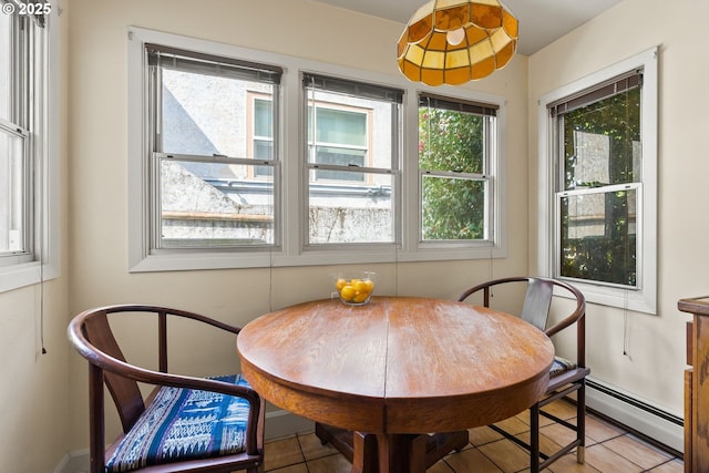 dining room featuring a baseboard heating unit and light tile patterned floors