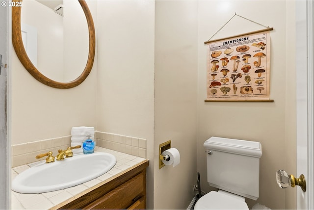 half bathroom featuring toilet and vanity