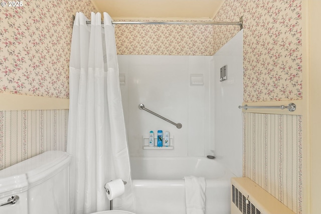 bathroom with wallpapered walls, toilet, radiator, and shower / bath combo