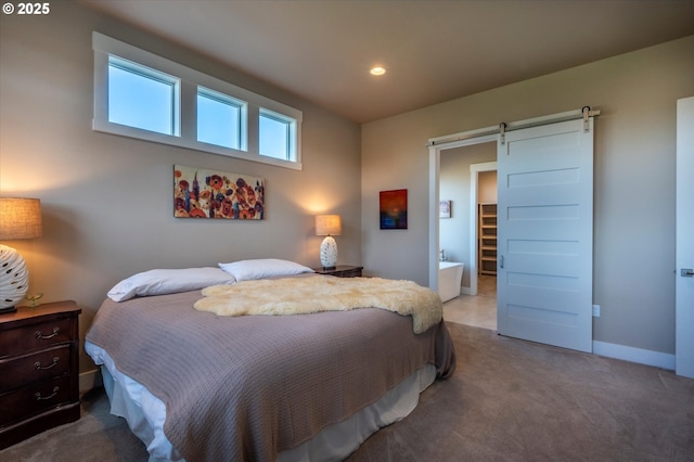 bedroom featuring a barn door and carpet