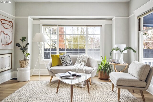 sitting room featuring baseboards and wood finished floors