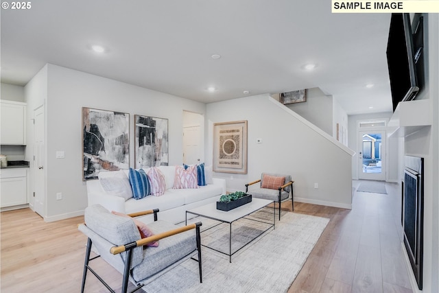 living room featuring a fireplace and light hardwood / wood-style flooring