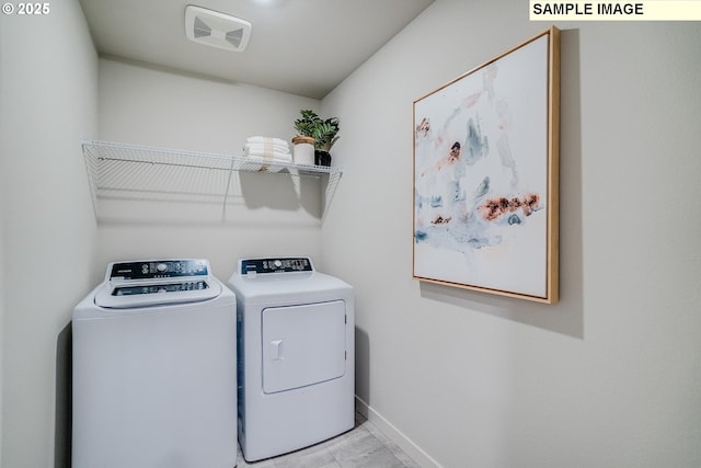 laundry area featuring light tile patterned flooring and separate washer and dryer