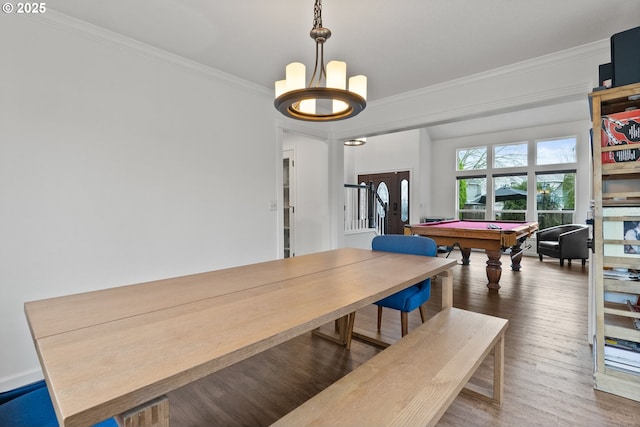 dining space with dark hardwood / wood-style flooring, ornamental molding, and billiards