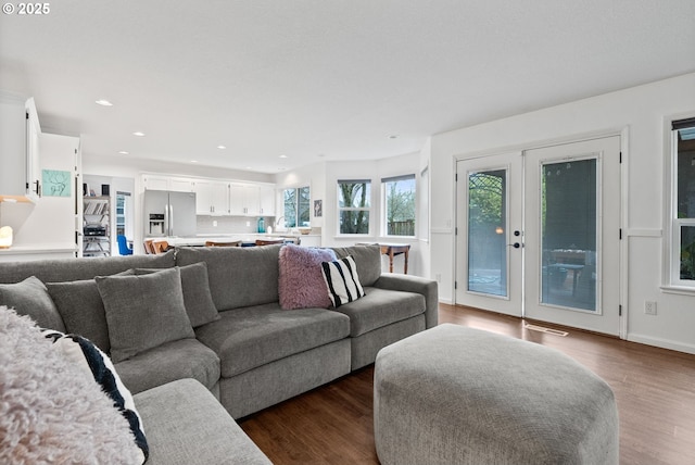 living room with french doors and dark hardwood / wood-style floors