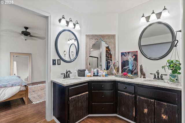 bathroom featuring ceiling fan, wood-type flooring, and vanity