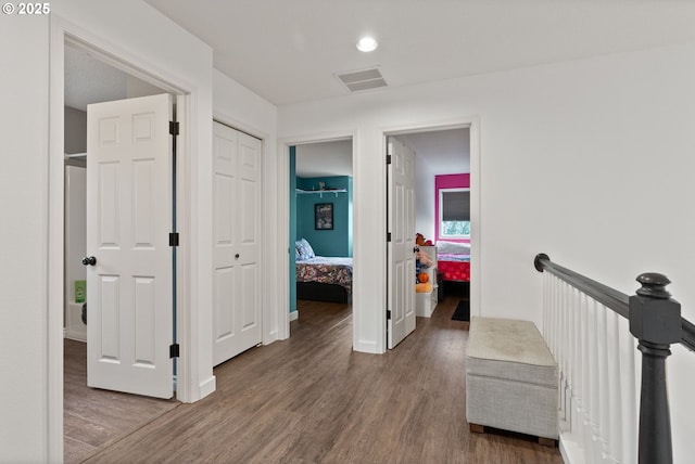 hallway with dark hardwood / wood-style flooring