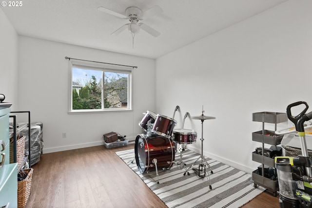 workout room with ceiling fan and hardwood / wood-style floors