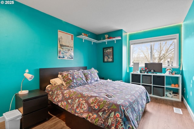 bedroom with hardwood / wood-style flooring