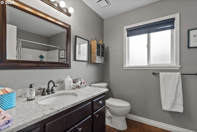 bathroom with toilet, a shower with shower curtain, vanity, and hardwood / wood-style flooring