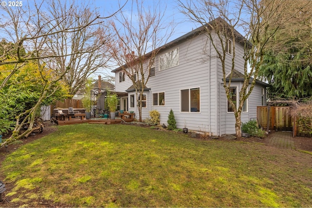 rear view of house with a yard and an outdoor hangout area