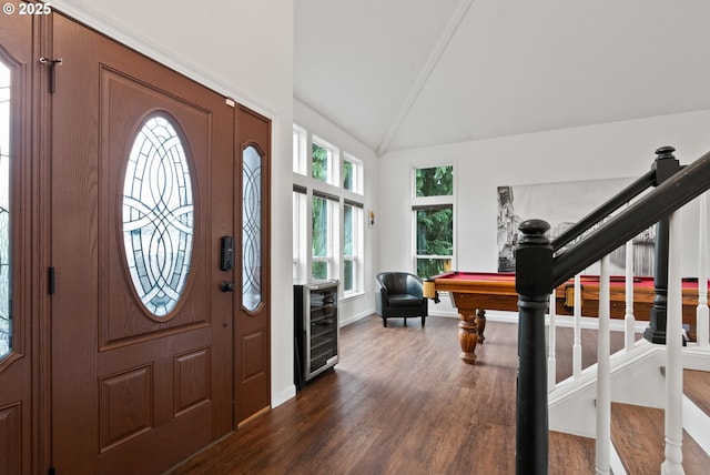 entrance foyer with beverage cooler, vaulted ceiling, plenty of natural light, and dark wood-type flooring