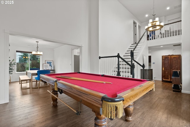 rec room featuring pool table, dark wood-type flooring, a chandelier, and a high ceiling