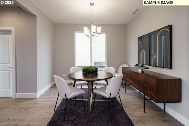 dining room featuring a chandelier and light hardwood / wood-style floors