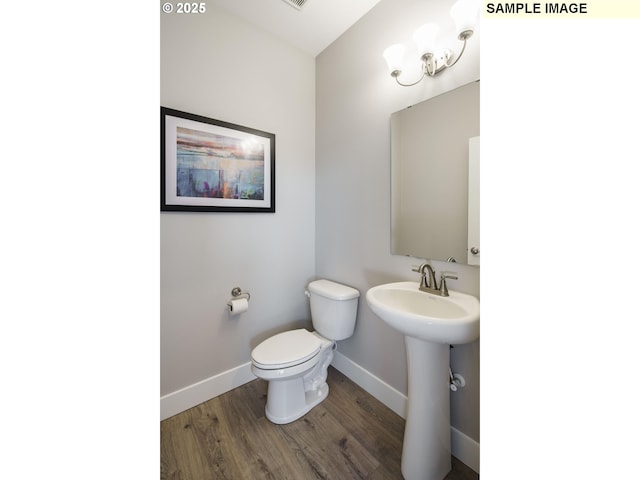 bathroom featuring hardwood / wood-style floors, sink, and toilet