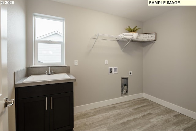 clothes washing area featuring washer hookup, light hardwood / wood-style floors, sink, and electric dryer hookup