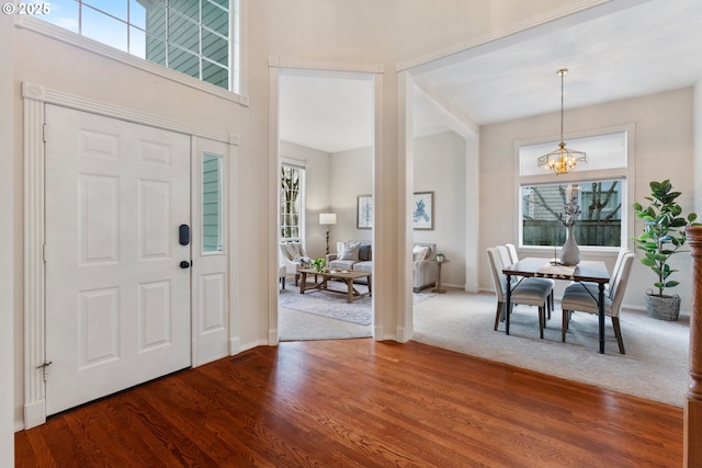 entrance foyer with an inviting chandelier and wood-type flooring