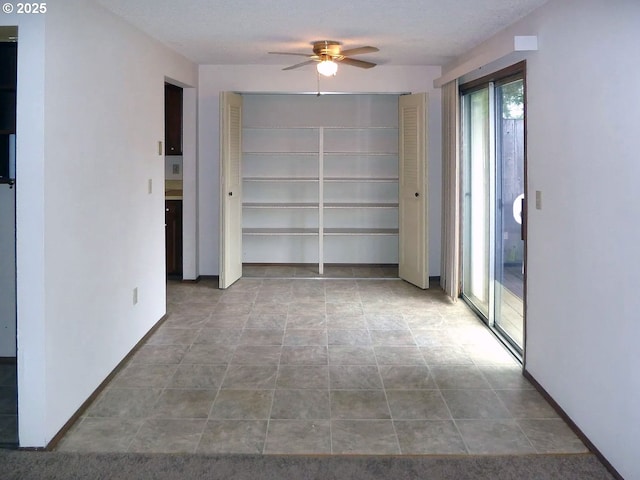 unfurnished room featuring ceiling fan and a textured ceiling