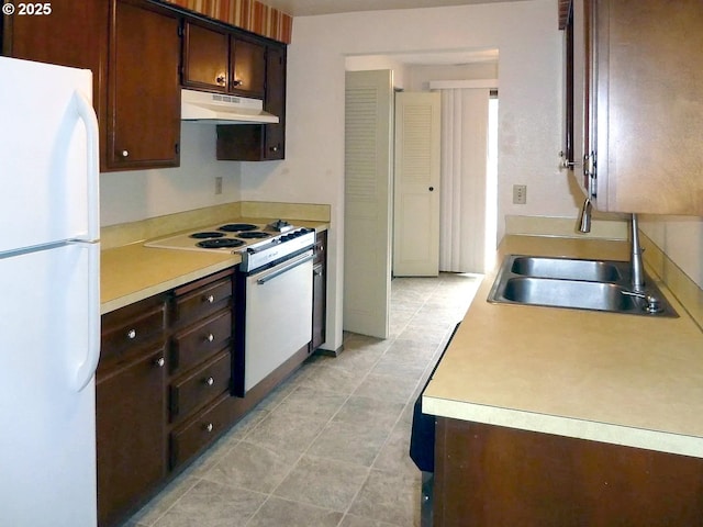 kitchen featuring white fridge, electric range oven, sink, and dark brown cabinets