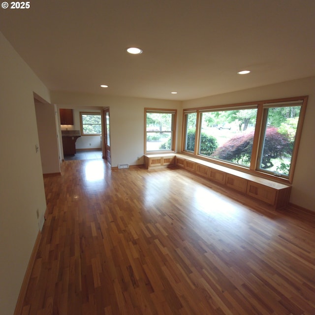 spare room with wood finished floors, recessed lighting, and baseboards