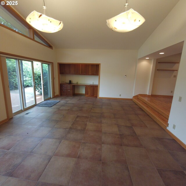 unfurnished living room with high vaulted ceiling, baseboards, and recessed lighting