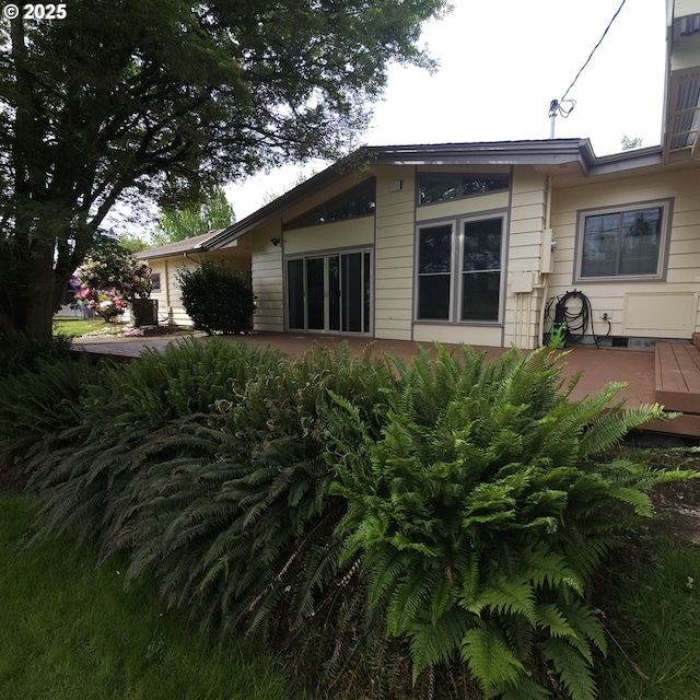 back of house with a wooden deck