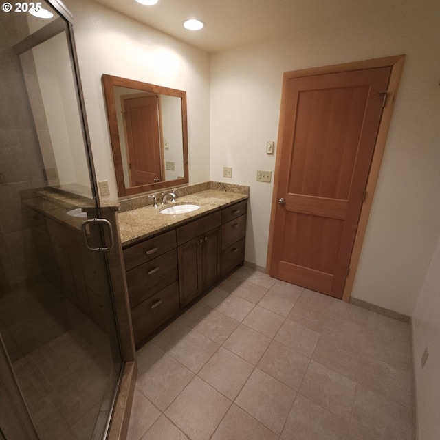 bathroom featuring tile patterned flooring, vanity, a stall shower, recessed lighting, and baseboards