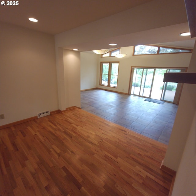 empty room with recessed lighting, baseboards, and wood finished floors