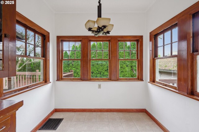 unfurnished sunroom featuring a chandelier