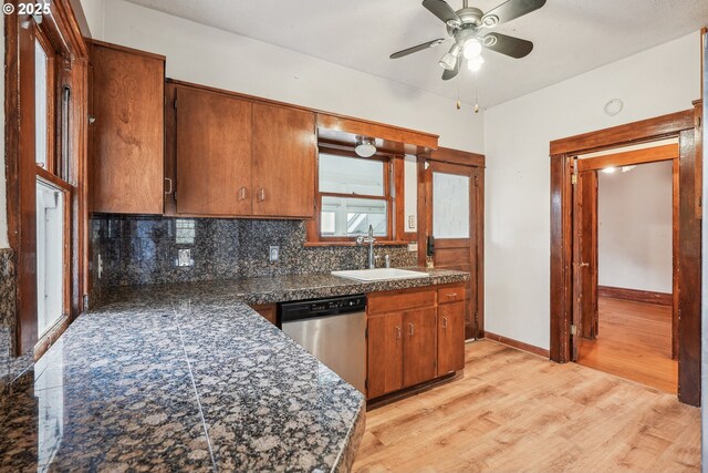 kitchen featuring ceiling fan, dishwasher, sink, tasteful backsplash, and light hardwood / wood-style floors