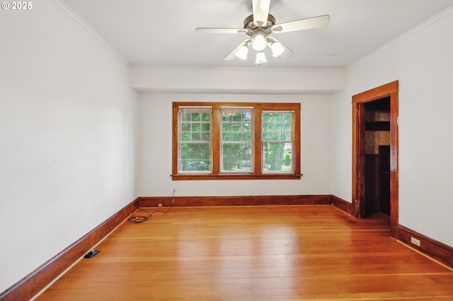 unfurnished room with crown molding, light hardwood / wood-style flooring, and ceiling fan