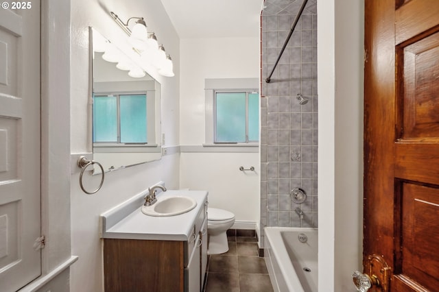 full bathroom featuring tile patterned floors, toilet, vanity, and tiled shower / bath