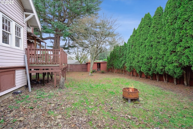 view of yard with a fire pit and a deck