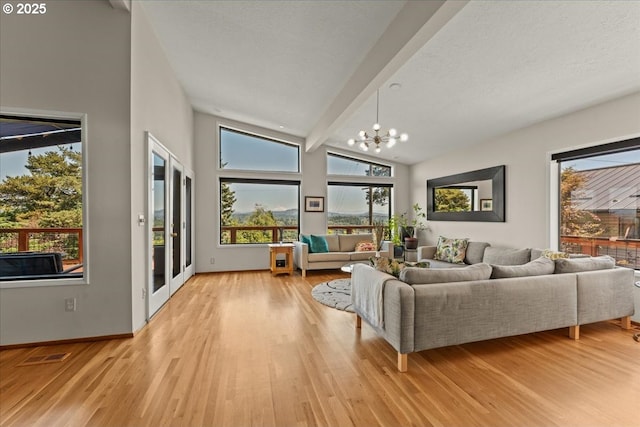 7237 S Corbett Ave, Portland, OR 97219 - living area featuring light wood-style flooring and a chandelier