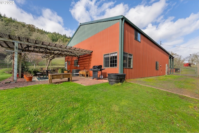 back of house with fence, a pergola, a lawn, and a patio